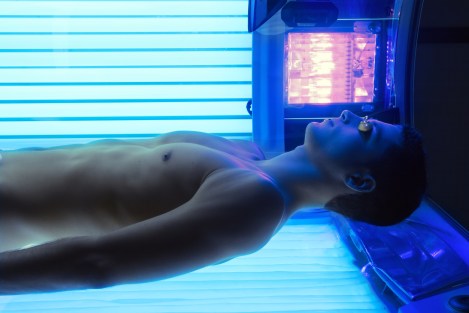 Tanning solarium young man laying